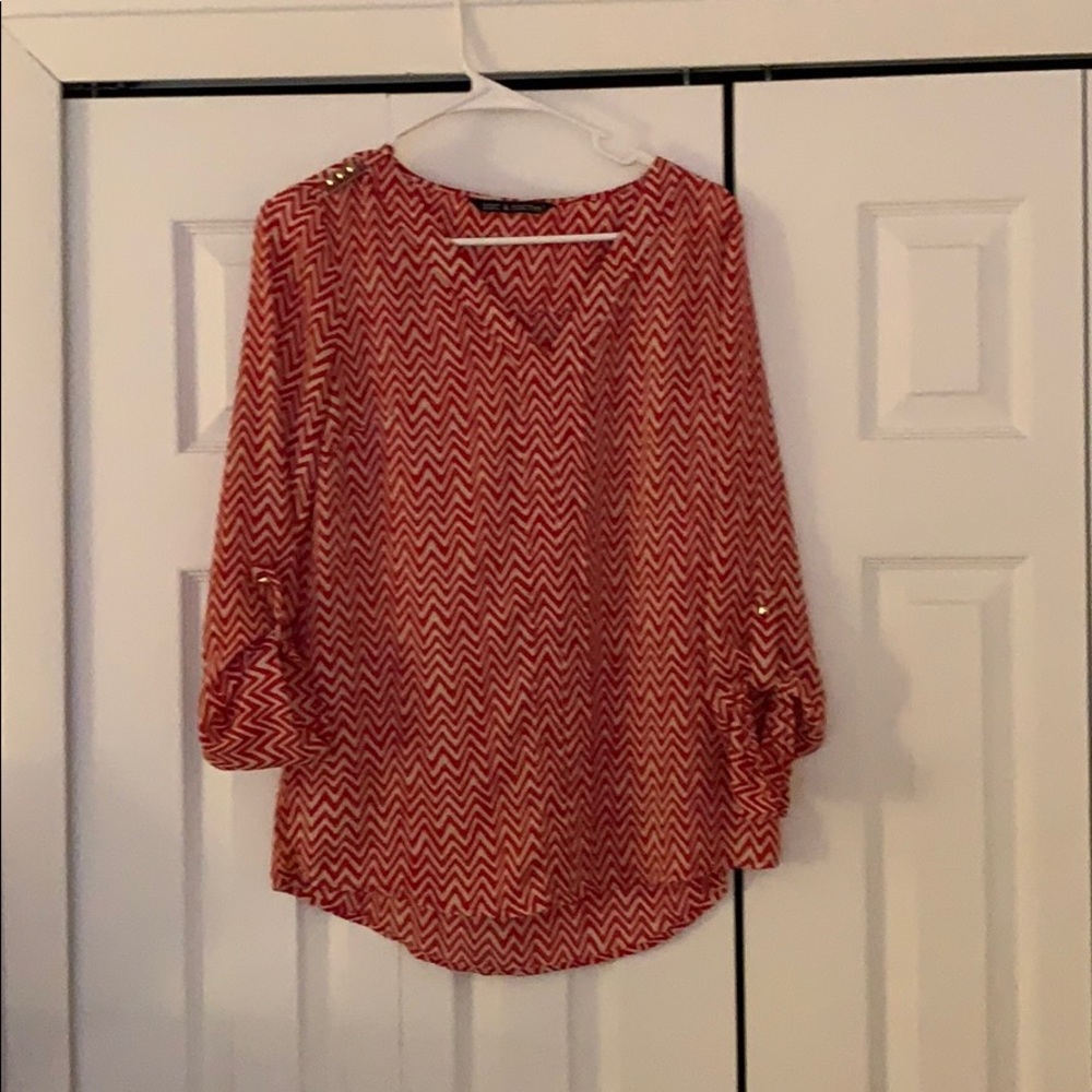 Women’s red and white chevron patterned blouse